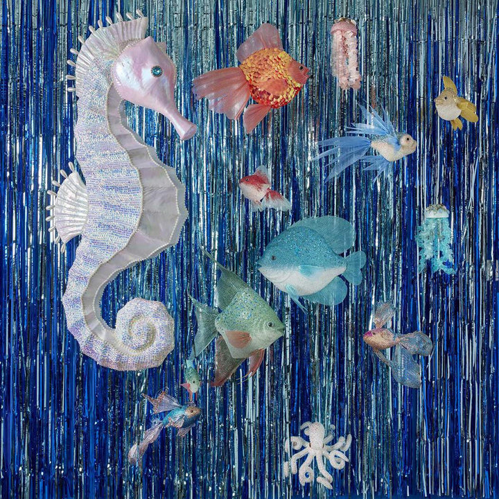 Decorative curtain with seahorse and fish patterns on a blue tinsel background