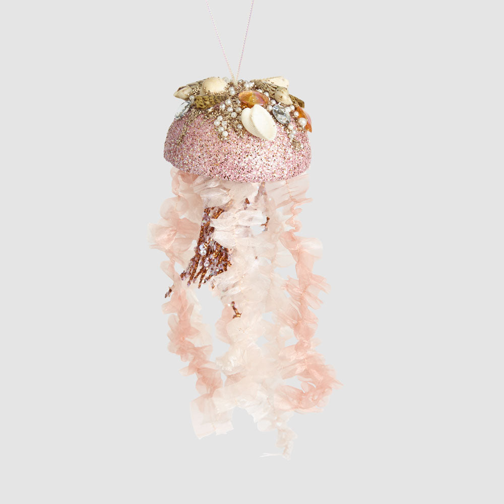 Decorative jellyfish ornament with pink glittery top and white body on a light gray background