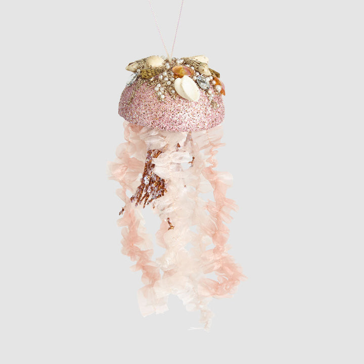 Decorative jellyfish ornament with pink glittery top and white body on a light gray background